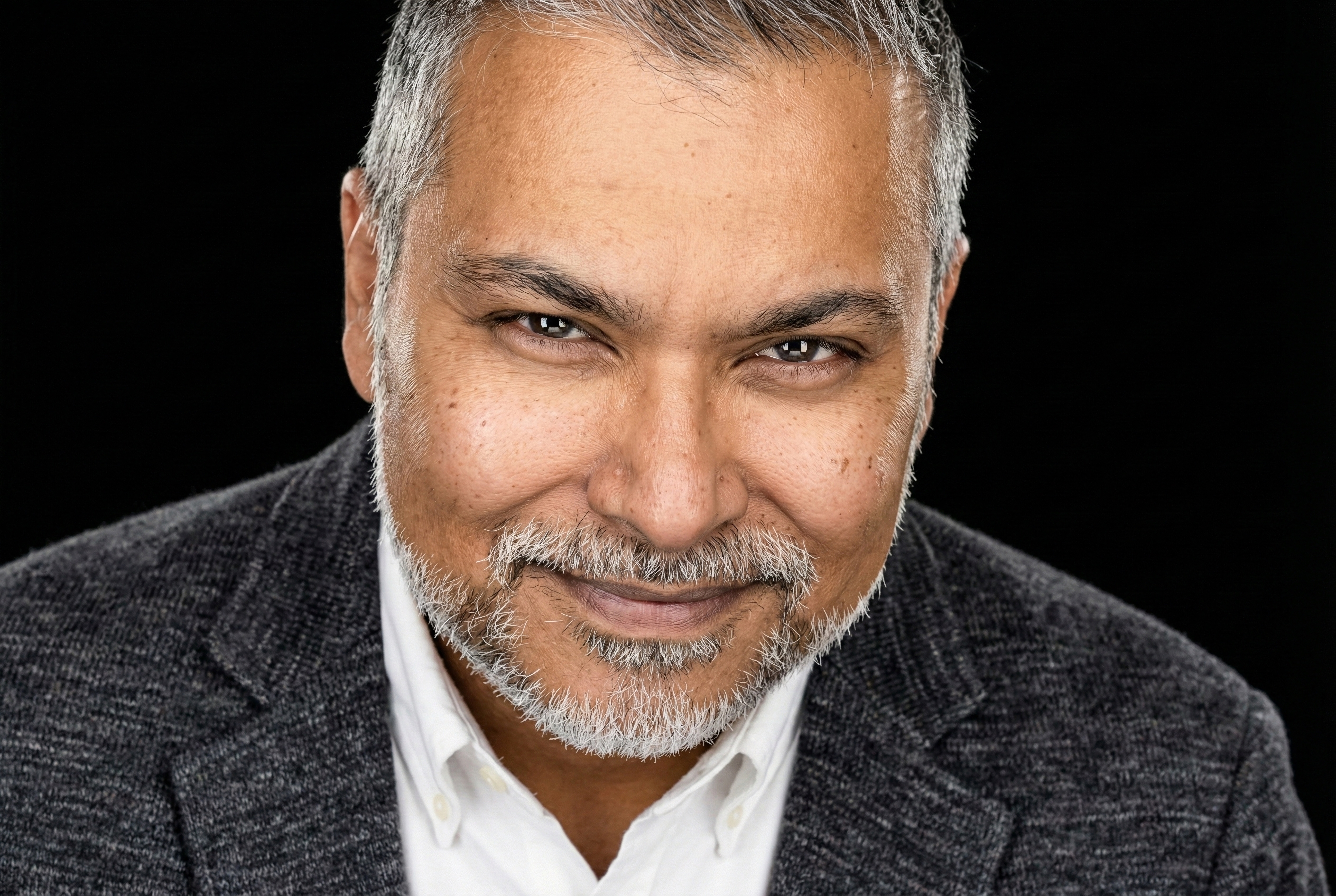 Veer Hossain in a charcoal jacket and white shirt.